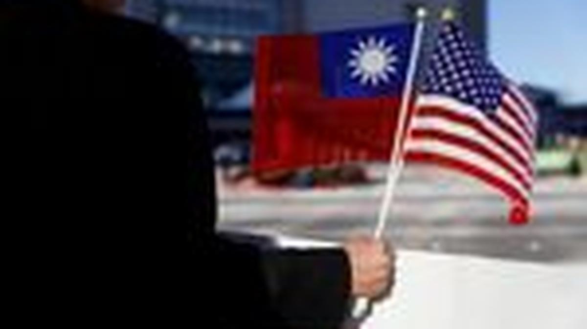 FILE PHOTO: A man holds the flags of Taiwan and the United States during Taiwanese President Tsai Ing-wen's stopover after her visit to Latin America, in Burlingame, California, U.S., January 14, 2017. REUTERS/Stephen Lam/File Photo