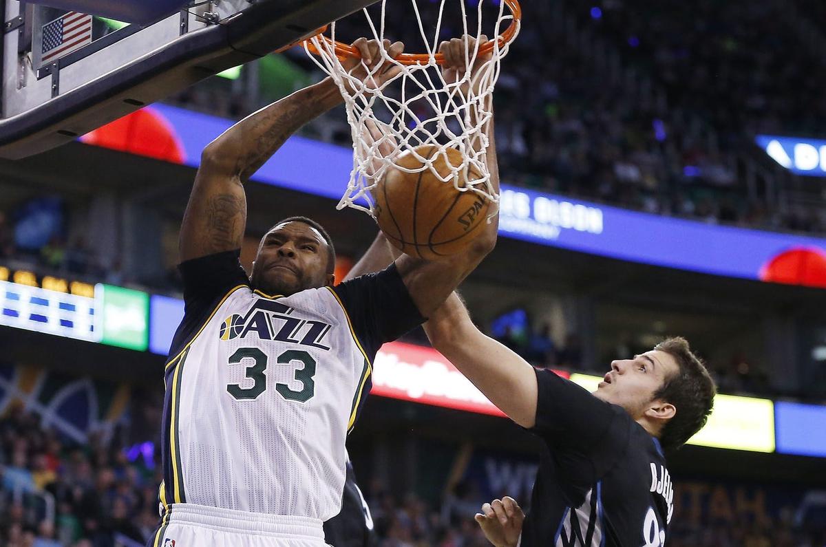 Apr 1, 2016; Salt Lake City, UT, USA; Utah Jazz forward Trevor Booker (33) dunks the ball against Minnesota Timberwolves forward Nemanja Bjelica (88) in the third quarter at Vivint Smart Home Arena. The Utah Jazz defeated the Minnesota Timberwolves 98-85. Mandatory Credit: Jeff Swinger-USA TODAY Sports