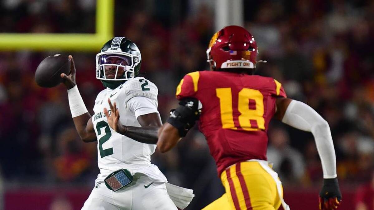  Sep 20, 2025; Los Angeles, California, USA; Michigan State Spartans quarterback Aidan Chiles (2) throws under pressure from Southern California Trojans linebacker Eric Gentry (18) during the first half at the Los Angeles Memorial Coliseum. Mandatory Credit: Gary A. Vasquez-Imagn Images | Gary A. Vasquez-Imagn Images 