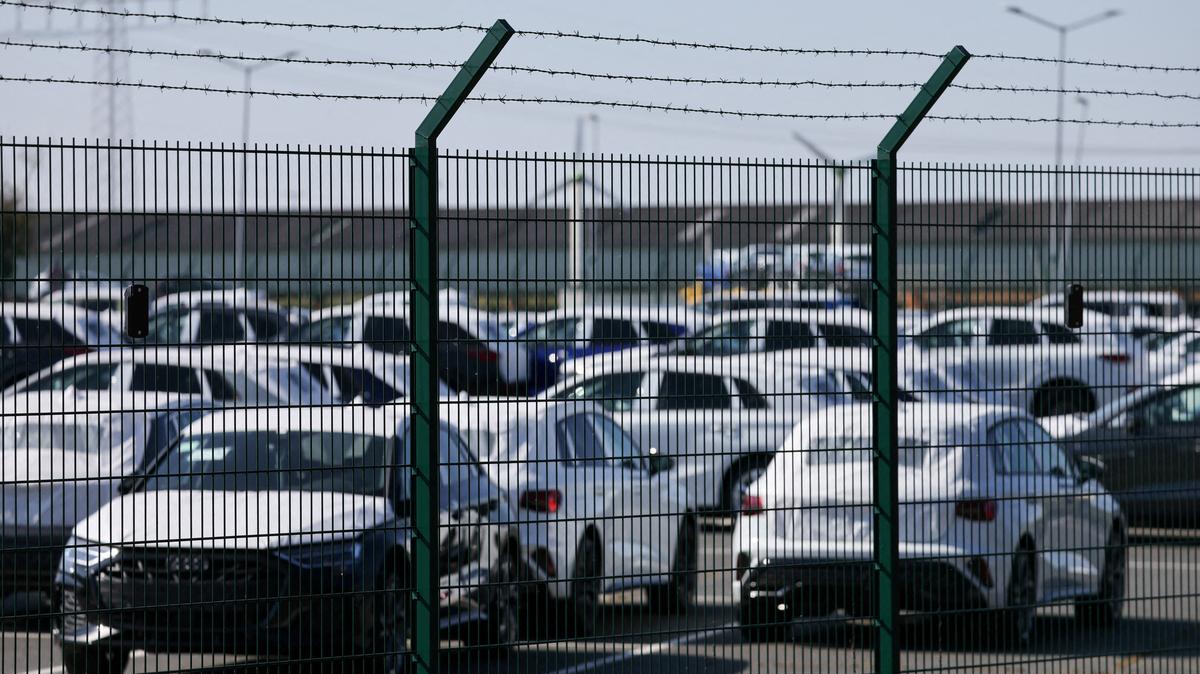 Cars of the Volkswagen Group intended for export to the United States are seen behind a fence at the seaport of Emden near the estuary, where the River Ems flows into the North Sea, in Emden, Germany, April 2, 2025. REUTERS/Wolfgang Rattay