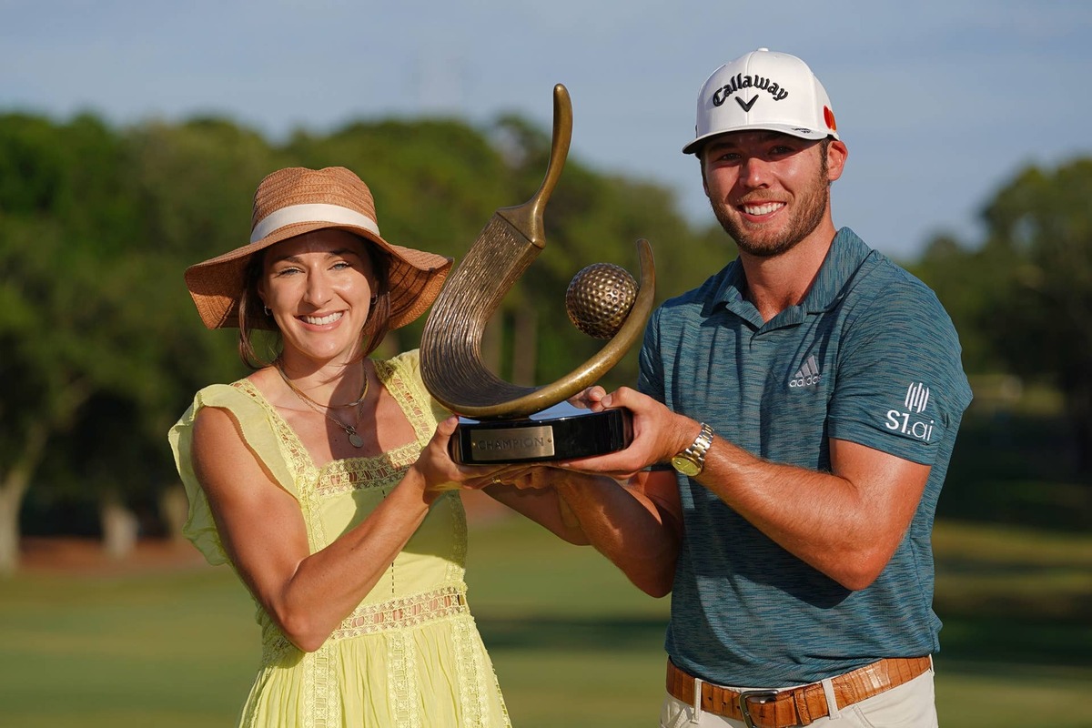  May 2, 2021; Palm Harbor, Florida, USA; Sam Burns and his wife Caroline Burns pose with the trophy after winning the Valspar Championship golf tournament. Jasen Vinlove-Imagn Images 