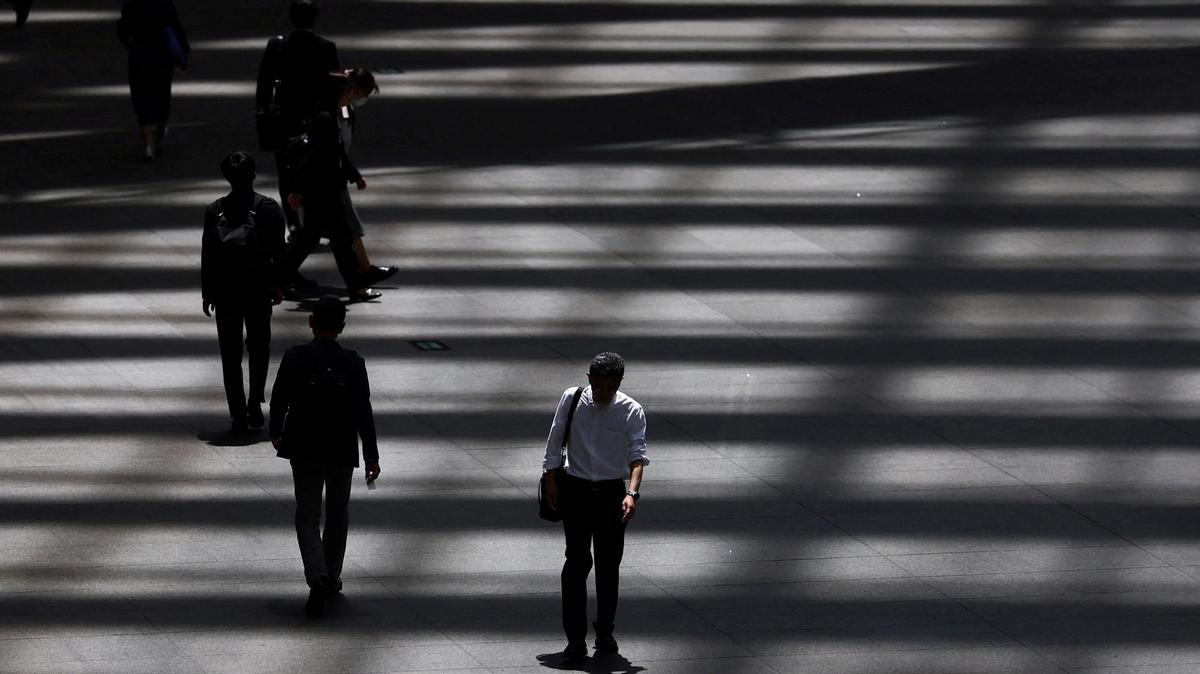 People walk through a convention hall in Tokyo, Japan, May 15, 2025.  REUTERS/Issei Kato