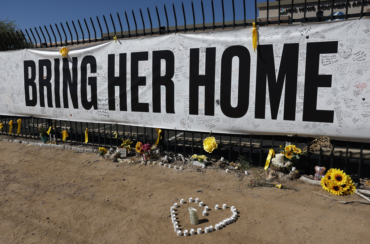  Candles and flowers are placed at a Nancy Guthrie memorial in front of the KVOA news station on March 3, 2026, in Tucson, Arizona. 