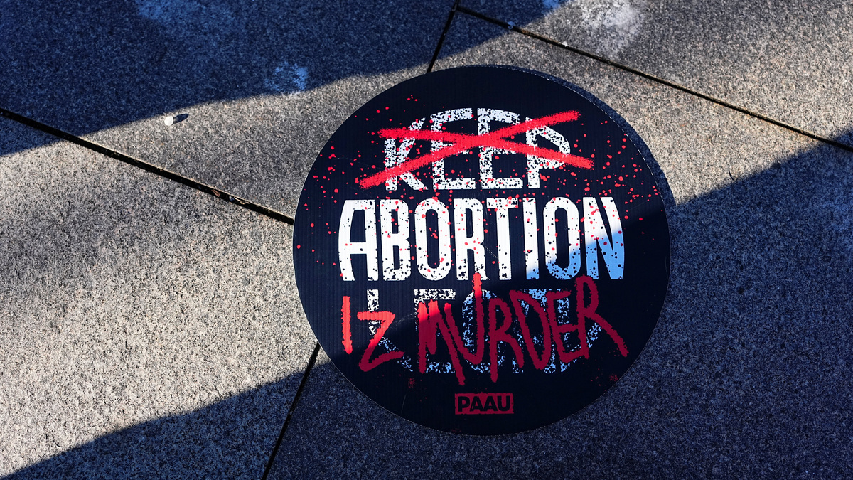 FILE PHOTO: A banner is seen during a protest to ban the abortion pill, outside the U.S. Department of Health and Human Services (HHS) in Washington, D.C., U.S., January 22, 2026. REUTERS/Aaron Schwartz/File Photo