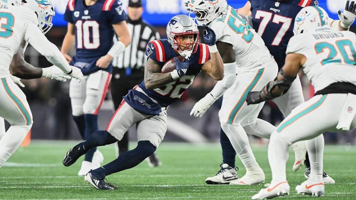  Jan 4, 2026; Foxborough, Massachusetts, USA; New England Patriots running back TreVeyon Henderson (32) runs the ball against Miami Dolphins center Aaron Brewer (55) during the first quarter at Gillette Stadium. Mandatory Credit: Brian Fluharty-Imagn Images | Brian Fluharty-Imagn Images 