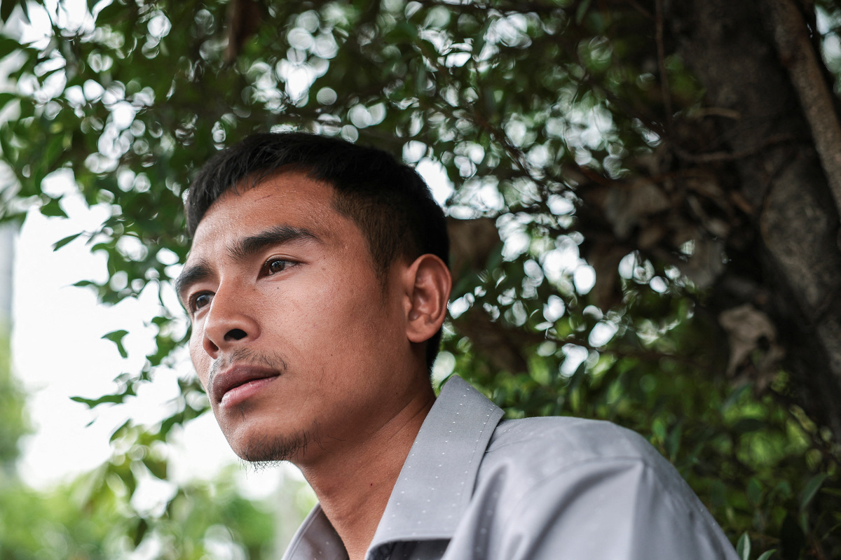 Noppadon Wongsuvan, 33, a Thai crew member of the cargo ship Mayuree Naree that was struck on March 11, killing three crew members, while sailing through the Strait of Hormuz, looks on during an interview with Reuters after the Central Labour Court accepts a lawsuit accusing Thailand-based company Precious Shipping of ordering the vessel to sail through the waterway despite military tensions between the U.S. and Iran, in Bangkok, Thailand, July 10, 2026. REUTERS/Chalinee Thirasupa