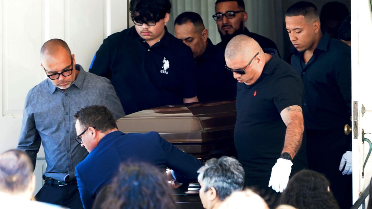 Pallbearers carry the body of Eduardo Uvaldo, who was killed Monday during a mass shooting at the Fourth of July parade in Highland Park, Ill., from the Memorial Chapel funeral home after visitation and a service Saturday, July 9, 2022, in Waukegan, Ill. (AP Photo/Charles Rex Arbogast)