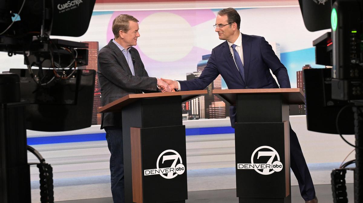 Sen. Michael Bennet, left, and Attorney General Phil Weiser, both running for the Democratic nomination for governor of Colorado, shake hands after a debate at the Denver7 studios on Thursday, May 7, 2026, in Denver. Ahead of the June 30 primary, the two candidates debated issues facing the state during an event hosted by The Denver Post, Colorado Public Radio and Denver7. (RJ Sangosti/The Denver Post/TNS)