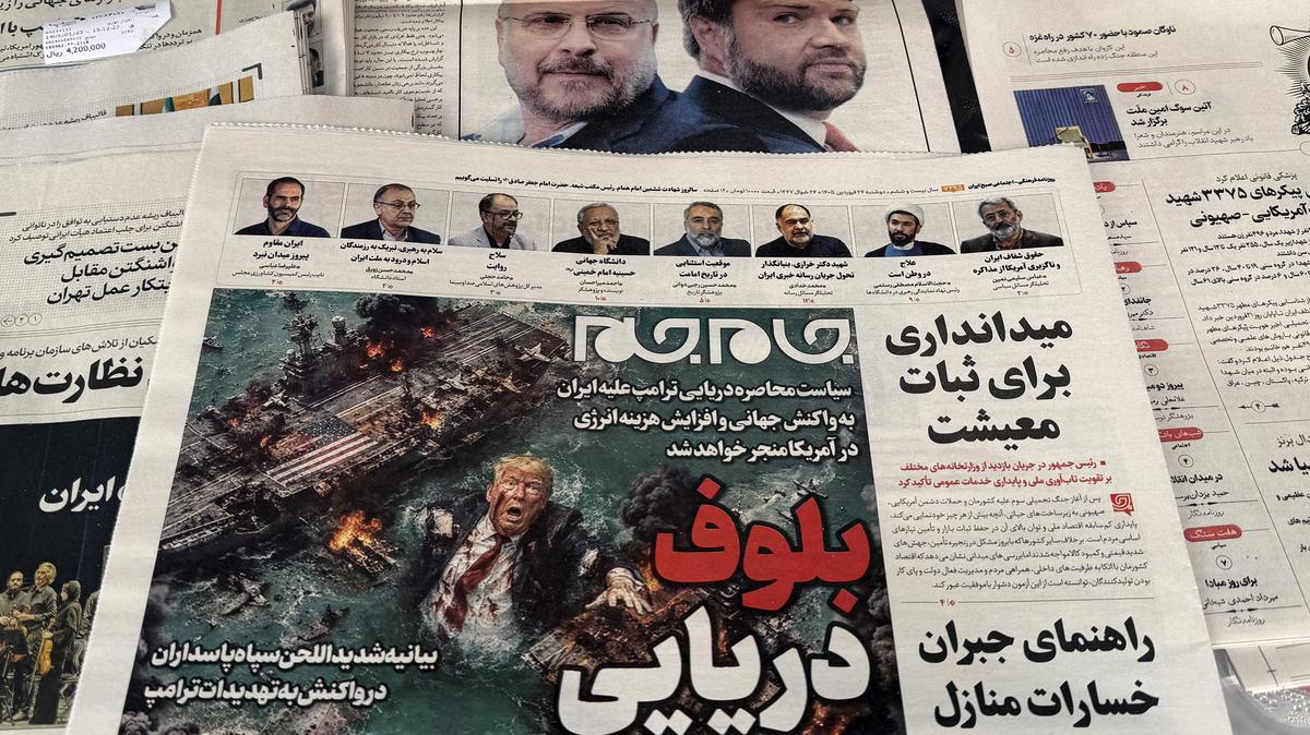 The front page of the Jam Jam newspaper on sale at a newsstand features a cartoon of U.S. President Donald Trump drowning in the Strait of Hormuz with the headline "Marine Bluff" in Tehran on April 13, 2026. (Atta Kenare/AFP/Getty Images/TNS)