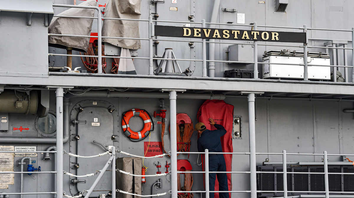 A US Navy sailor prepares rescue equipment during maintenance work aboard the mine countermeasures USS Devastator while docked at the US 5th Fleet Command in Bahrain's capital Manama on Dec. 17, 2019. (Mazen Mahdi/AFP via Getty Images/TNS)