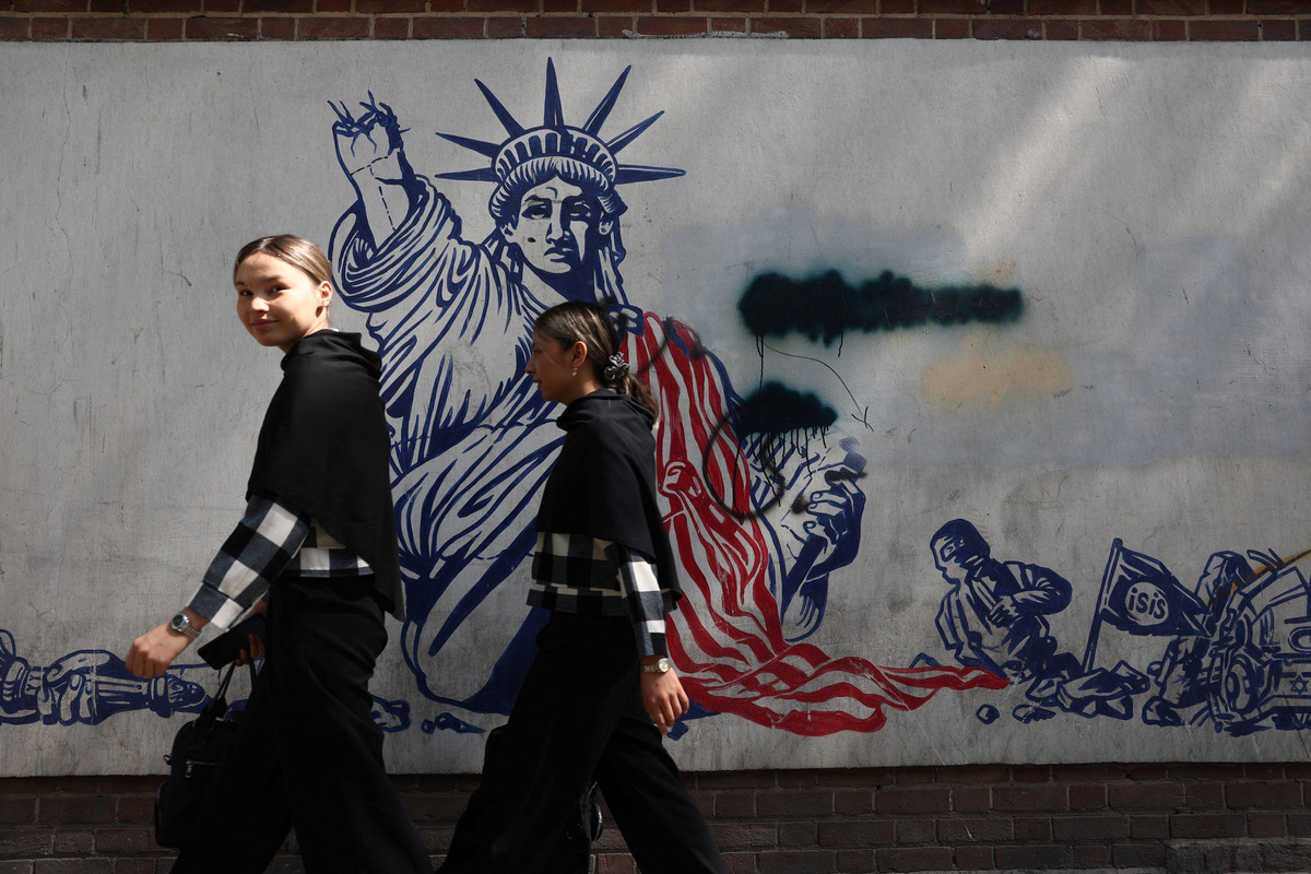 People walk near an anti-U.S. mural in Tehran, Iran, June 30, 2026. Majid Asgaripour/WANA (West Asia News Agency) via REUTERS