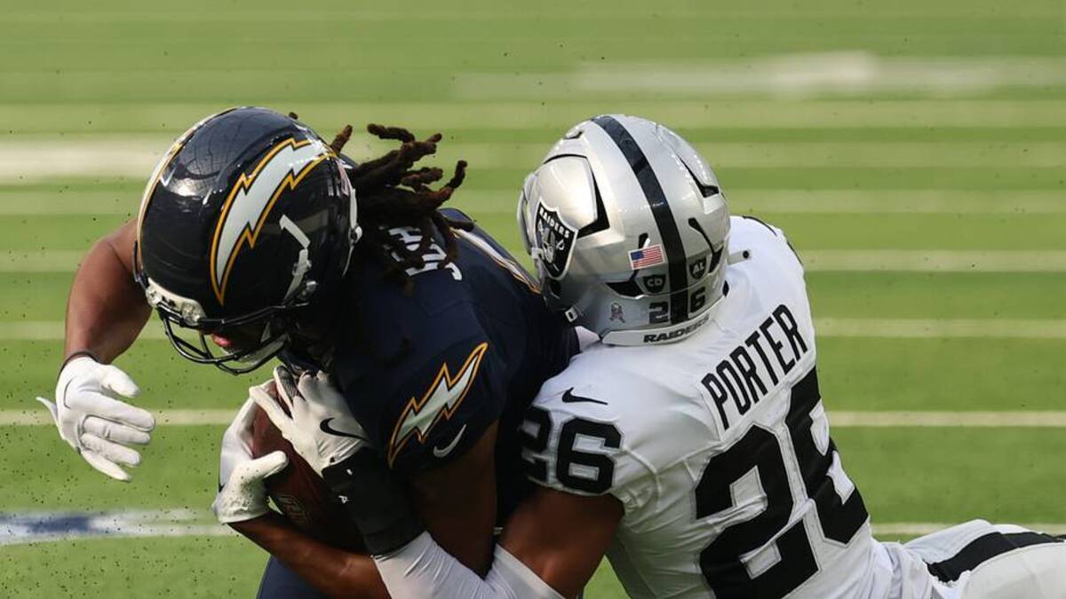  Nov 30, 2025; Inglewood, California, USA; Los Angeles Chargers wide receiver Quentin Johnston (1) makes a catch against the Las Vegas Raiders cornerback Darien Porter (26) during the first half at SoFi Stadium. Mandatory Credit: Kiyoshi Mio-Imagn Images | IMAGN IMAGES via Reuters Connect 