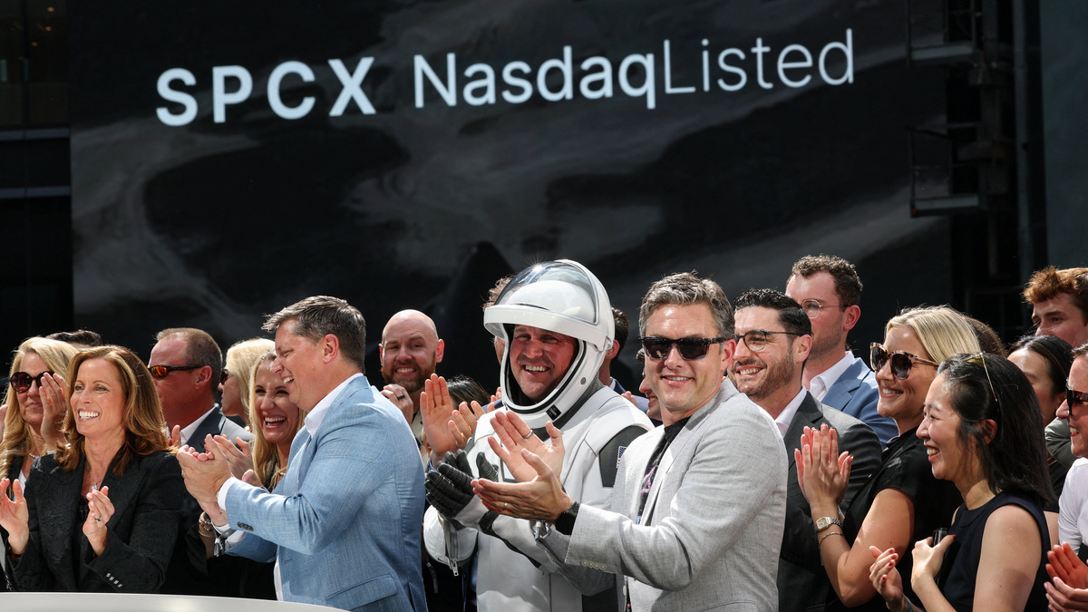 SpaceX leadership members and guests celebrate on a balcony at the Nasdaq MarketSite on the day of SpaceX's initial public offering (IPO), in New York City, U.S., June 12, 2026. REUTERS/Brendan McDermid