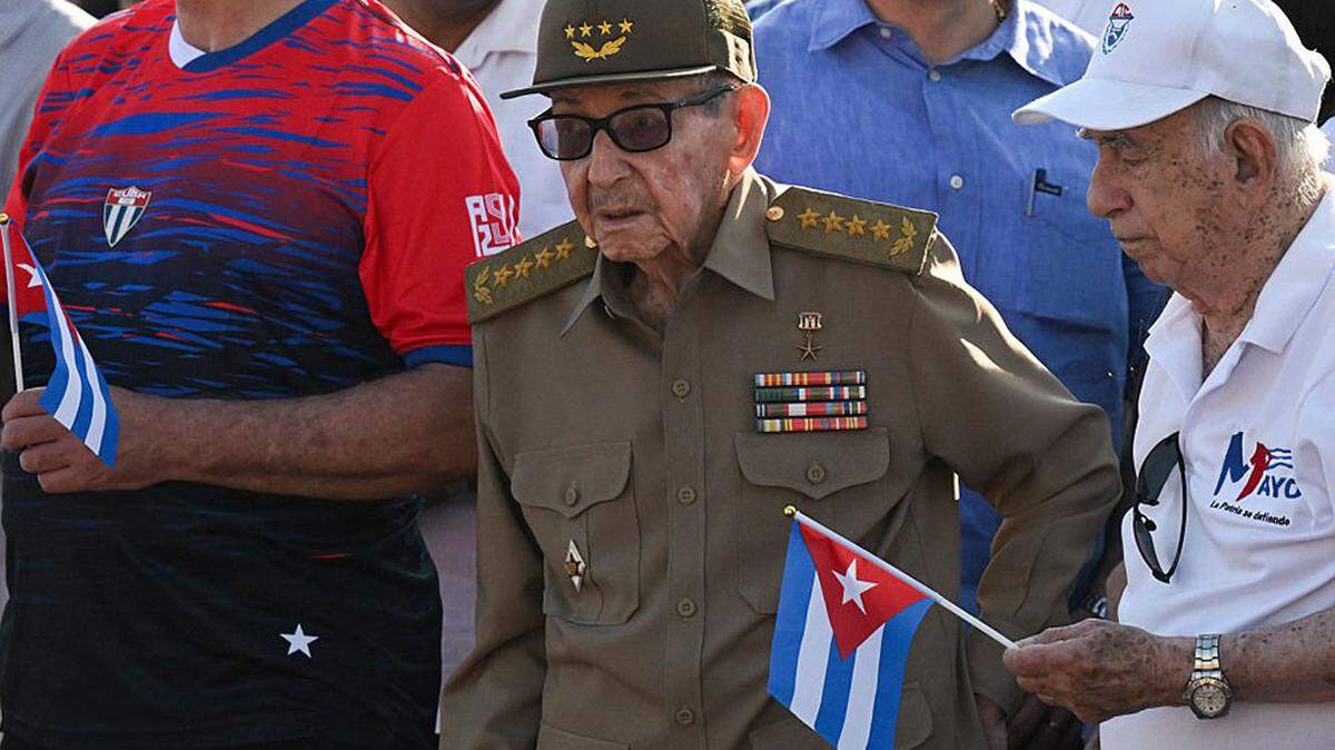 Cuba's former President Raul Castro, center, and former Vice President Jose Ramon Machado Ventura, right, attend a May Day rally in Havana on May 1. The United States on Wednesday announced murder charges against Castro and five fighter pilots in the Cuban military in a 1996 incident in which Cuban jets shot down planes operated by a group of exiles.