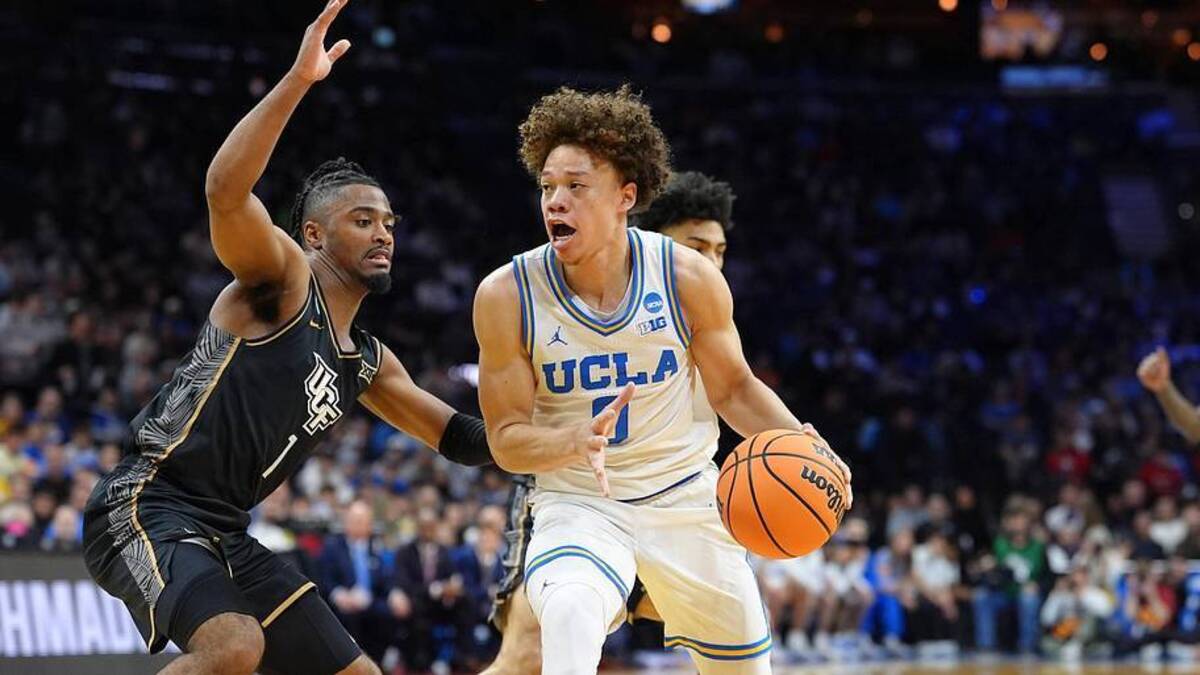 Mar 20, 2026; Philadelphia, PA, USA; UCLA Bruins guard Trent Perry (0) dribbles the ball against UCF Knights guard Themus Fulks (1) in the first half during a first round game of the men's 2026 NCAA Tournament at Xfinity Mobile Arena. Mandatory Credit: Kyle Ross-Imagn Images | Kyle Ross-Imagn Images 