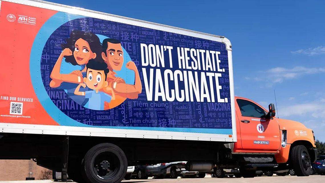 A truck with a sign encouraging vaccinations is seen outside the Public Health office in Austin, Texas, in February. Measles cases have been reported in 30 states this year.
