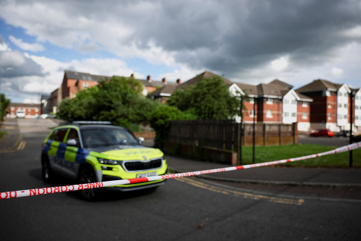A police vehicle sits near a cordon at the scene of a stabbing outside apartments in the Kinnaird Avenue area of north Belfast, after a knife attack on June 8 left a man seriously injured and prompted police to declare a critical incident, in Belfast, Northern Ireland, June 9, 2026. REUTERS/Isabel Infantes