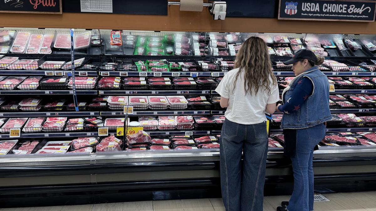 Customers shop for beef at a grocery store on April 06, 2026 in Los Angeles, California. Amid persistently high food inflation, the price of a pound of ground beef has risen to between roughly $6.49 and $8.96, often exceeding the federal minimum wage of $7.25 an hour, as supply shortages, drought, and disease affecting cattle herds drive costs higher while wages remain unchanged since 2009. (Justin Sullivan/Getty Images/TNS)