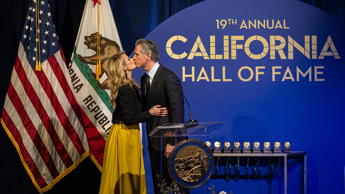 Gov. Gavin Newsom kisses First Partner Jennifer Siebel Newsom during the induction of the 19th class to the California Hall of Fame at the California Museum on Thursday, March 19, 2026, in Sacramento. The Newsoms’ finances have been obtained by the U.S. Department of Justice as part of a federal investigation. (Paul Kitagaki Jr./The Sacramento Bee/TNS)