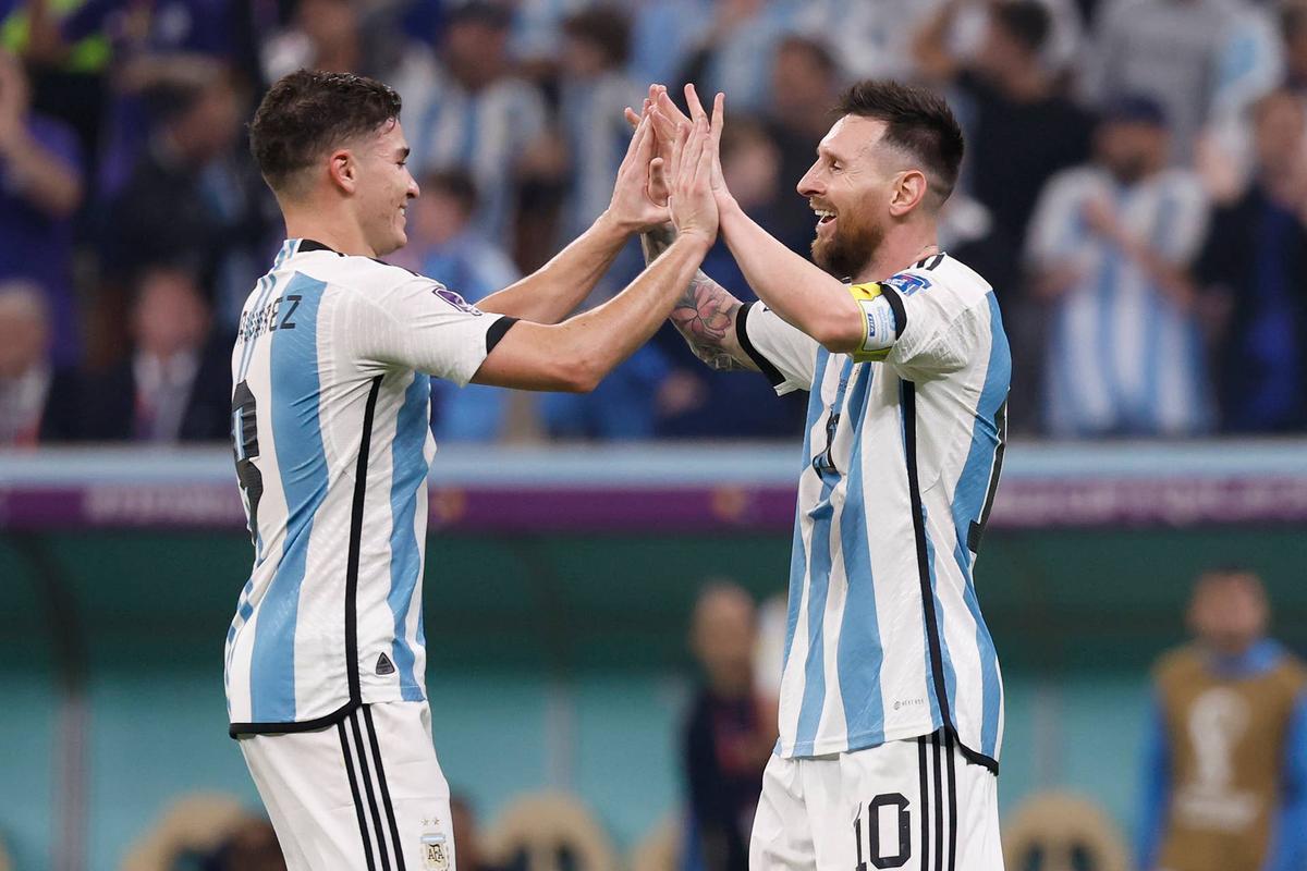  Argentina forward Julian Alvarez (9) celebrates with forward Lionel Messi during the 2022 FIFA World Cup Yukihito Taguchi-Imagn Images