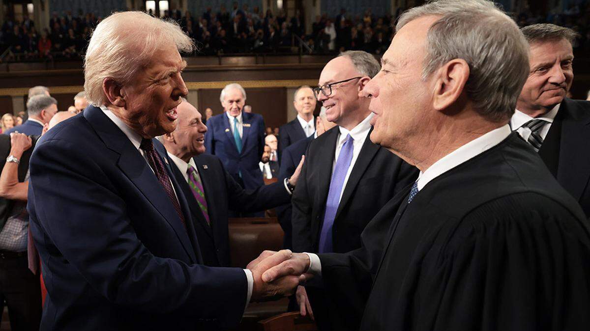 President Donald Trump greets Chief Justice of the United States John G. Roberts before Trump’s address to a joint session of Congress at the U.S. Capitol in Washington on March 4.