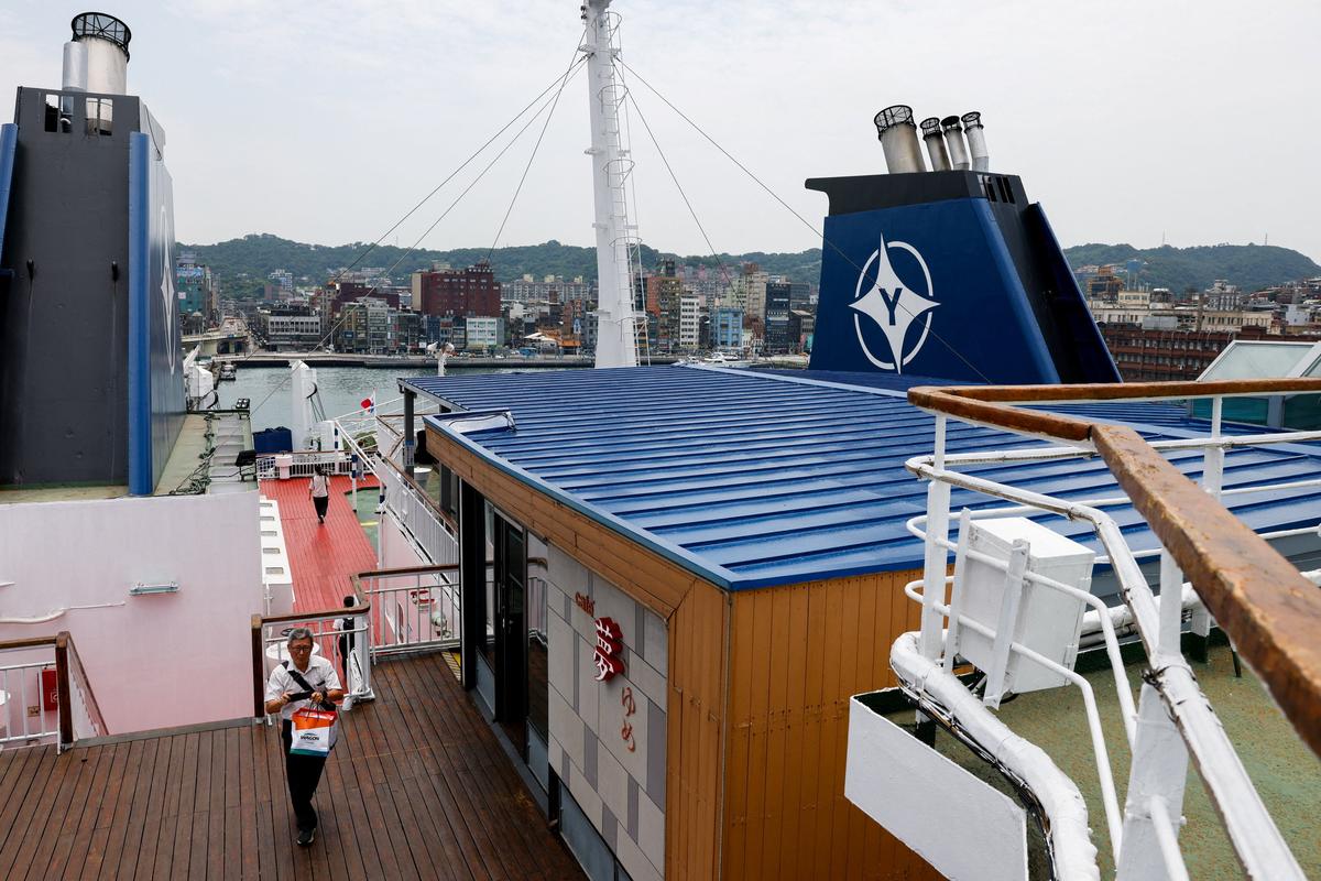 Government officials and members of the media attend a preview tour of the Yaima Maru ferry, which is set to operate between Taiwan and Japan's Ishigaki Island in Okinawa Prefecture,at Keelung, Taiwan, May 28, 2026. REUTERS/Ann Wang