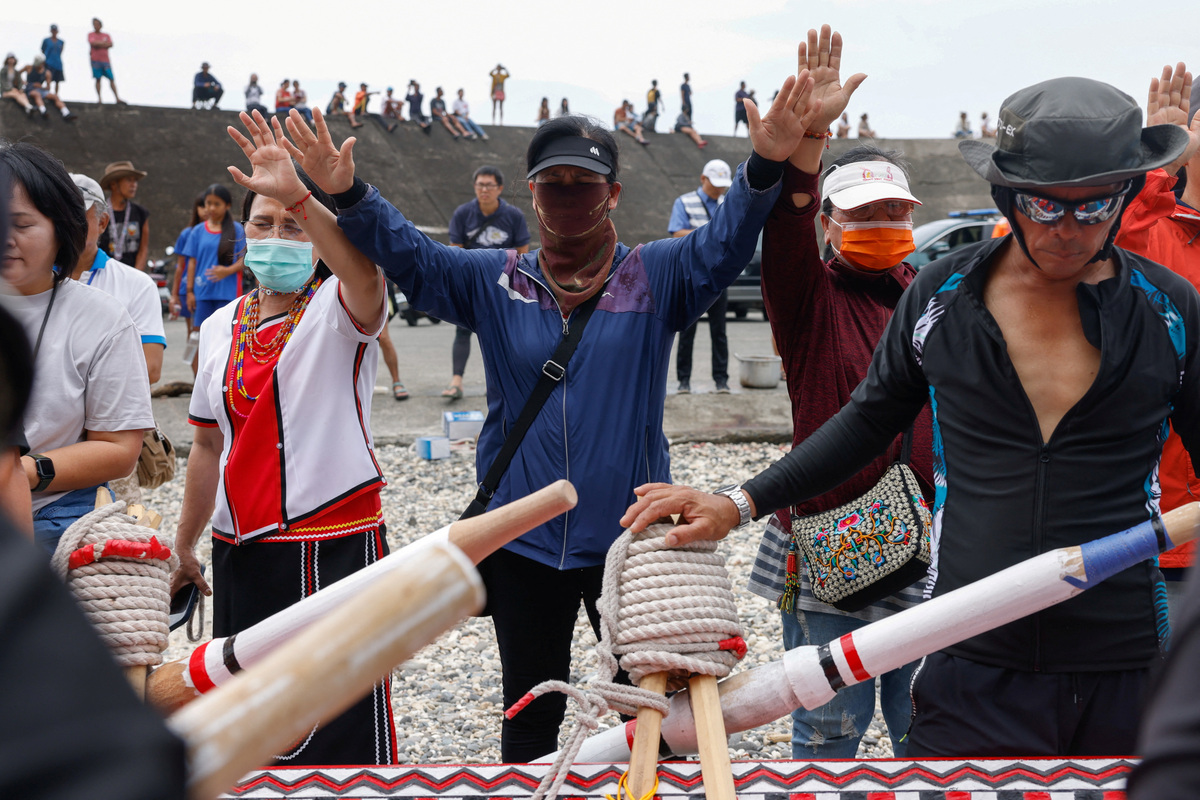 Women gather to pray for the crew before they set off on a journey in a traditional wooden canoe named Ovayan, or "Golden Friendship," to the Philippines' Batanes Islands, on Orchid Island, Taiwan, June 15, 2026. REUTERS/Ann Wang