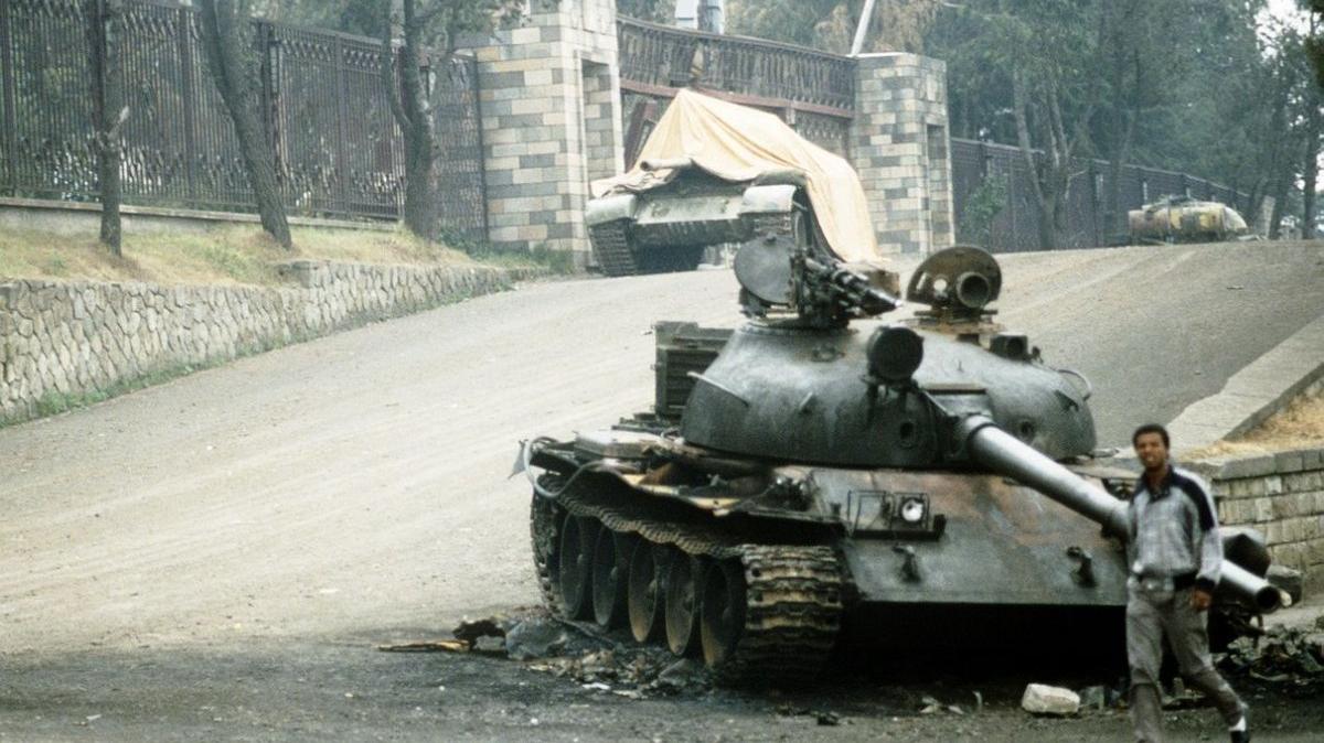 A local resident walks past a battle tank stranded outside the Ethiopian Presidential Palace in Addis Ababa on June 9, 1991, following a battle between rebel forces and the government. On May 28, 1991, Ethiopian rebels seized the presidential palace and tightened their control of the capital of Addis Ababa, effectively ending a 16-year civil war. File Photo by Master Sgt. Ed Boyce/U.S. Department of Defense