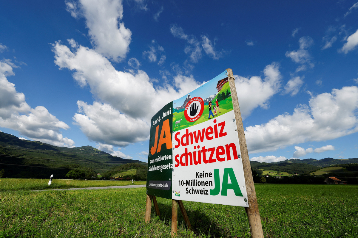 A sign stands in a field between Eichenwies and Eichberg, on the day of the vote on a plan backed by the right-wing Swiss People's Party (SVP) to limit population growth to 10 million inhabitants, Switzerland, June 14, 2026.  REUTERS/Michaela Stache