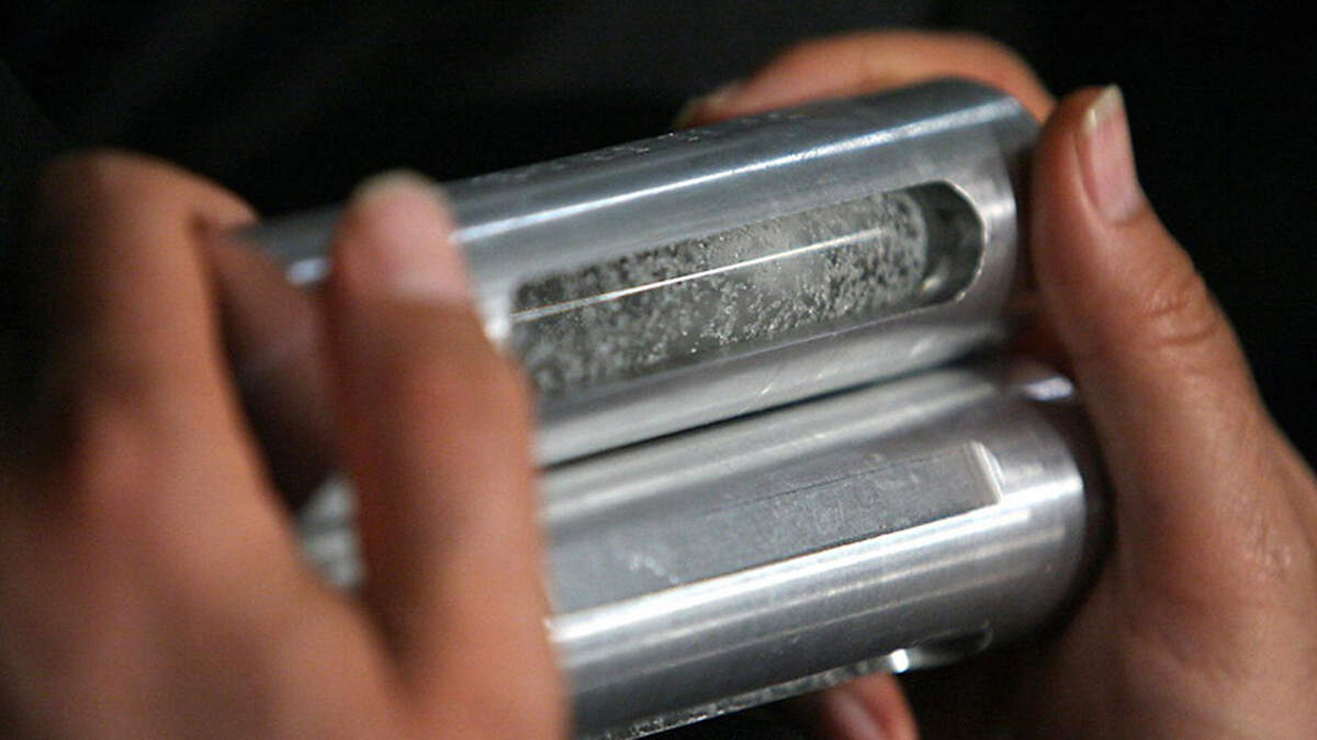 The chief of the Astan Qods Razavi museum carries a sample of enriched uranium in Mashhad, Iran, on April 11, 2006. Iran and the United States said on Sunday that they have reached a deal to end their war, which is expected to pave the way for talks on Tehran’s nuclear program.