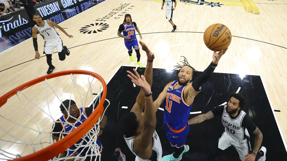 Jun 13, 2026; San Antonio, Texas, USA; New York Knicks guard Jalen Brunson (11) drives to the basket past San Antonio Spurs forward Julian Champagnie (30) during game five of the 2026 NBA Finals at Frost Bank Center. Mandatory Credit: Geoff Burke-Pool Photo via Imagn Images