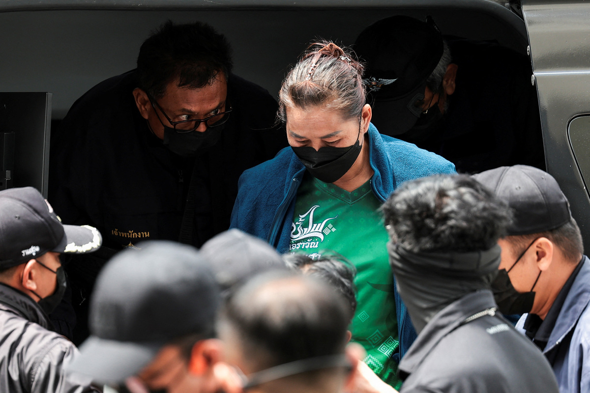 A Laotian national, suspected of sending drug parcels from a border province to Bangkok, is escorted by officials as she arrives at the Office of the Narcotics Control Board (ONCB) in Bangkok, Thailand, July 3, 2026. REUTERS/Chalinee Thirasupa