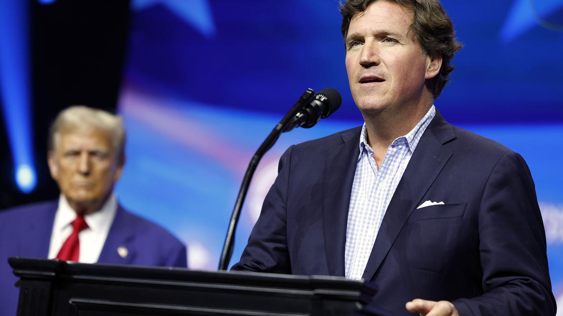 Political Commentator Tucker Carlson speaks alongside Republican presidential nominee, former U.S. President Donald Trump during a Turning Point Action campaign rally at the Gas South Arena on Oct, 23, 2024, in Duluth, Georgia. (Anna Moneymaker/Getty Images/TNS)