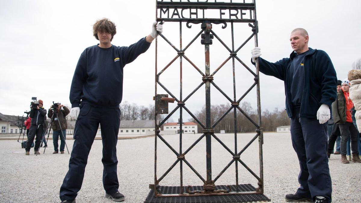 Workers present the stolen iron gate with the slogan "Arbeit macht frei" ("Work will set you free") after its return to the site in Dachau, Germany, Feburary 22, 2017. On April 29, 1945, troops of the U.S. Seventh Army liberated 32,000 prisoners at the Nazi regime's Dachau concentration camp. File Photo by Sebastian Widmann/EPA