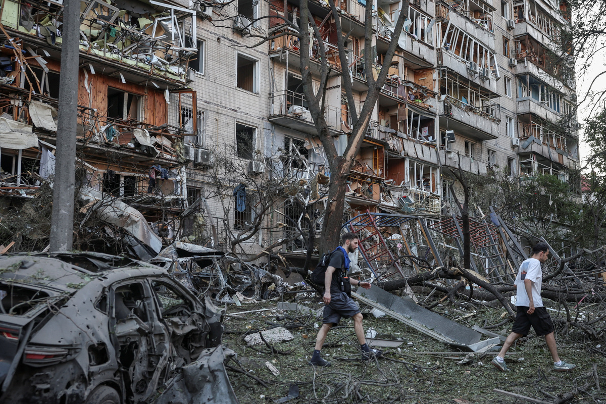 Residents pass through debris at a site of a Russian missile and drone strikes, amid Russia’s attack on Ukraine, in Kyiv, Ukraine, July 2, 2026. REUTERS/Alina Smutko
