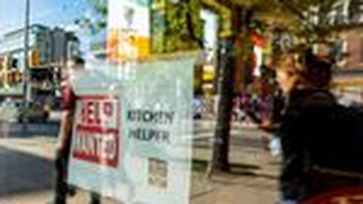 A help wanted sign hangs in a bar window along Queen Street West in Toronto Ontario, Canada June 10, 2022. REUTERS/Carlos Osorio