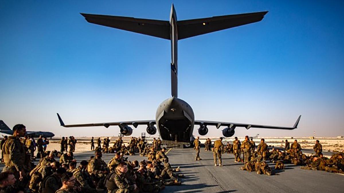 Marines assigned to the 24th Marine Expeditionary Unit (MEU) await a flight to Kabul Afghanistan, at Al Udeied Air Base, Qatar Tuesday, Aug. 17, 2021. Marines are assisting the Department of State with a drawdown of designated personnel in Afghanistan. (1st Lt. Mark Andries/U.S. Marine Corps via AP)