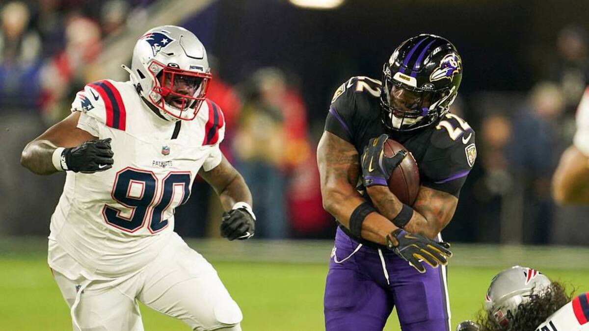  Dec 21, 2025; Baltimore, Maryland, USA; Baltimore Ravens running back Derrick Henry (22) runs the ball against New England Patriots defensive tackle Christian Barmore (90) and linebacker Jahlani Tavai (48) during the first quarter of the game at M&T Bank Stadium. Mandatory Credit: Mitch Stringer-Imagn Images | IMAGN IMAGES via Reuters Connect 