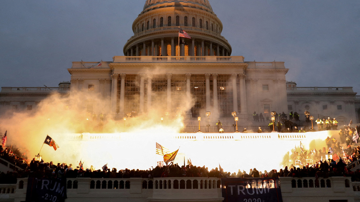 An explosion caused by a police munition is seen while supporters of U.S. President Donald Trump riot at the U.S. Capitol Building in Washington, U.S., January 6, 2021. REUTERS/Leah Millis