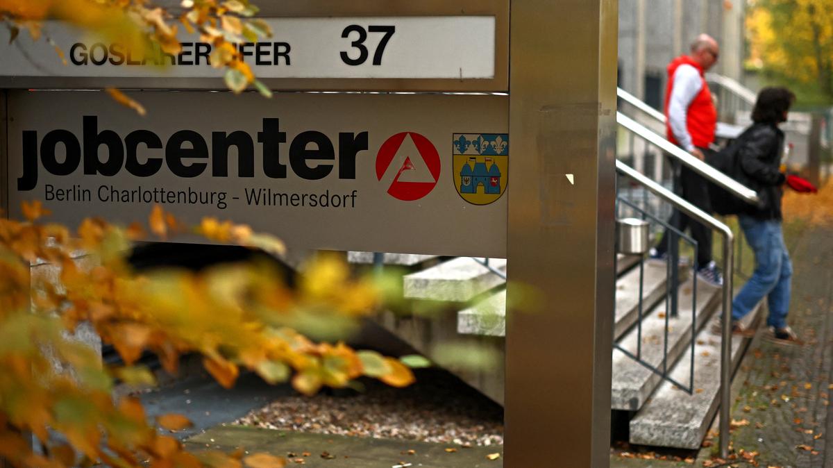People walk outside a jobcenter in Berlin, Germany, October 14, 2025. REUTERS/Lisi Niesner