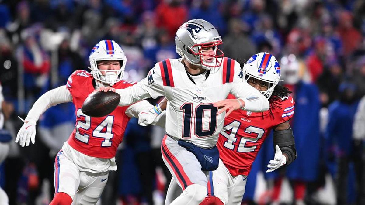  Dec 22, 2024; Orchard Park, New York, USA; New England Patriots quarterback Drake Maye (10) throws a pass under pressure from Buffalo Bills safety Cole Bishop (24) and linebacker Dorian Williams (42) in the fourth quarter at Highmark Stadium. Mandatory Credit: Mark Konezny-Imagn Images | Mark Konezny-Imagn Images 