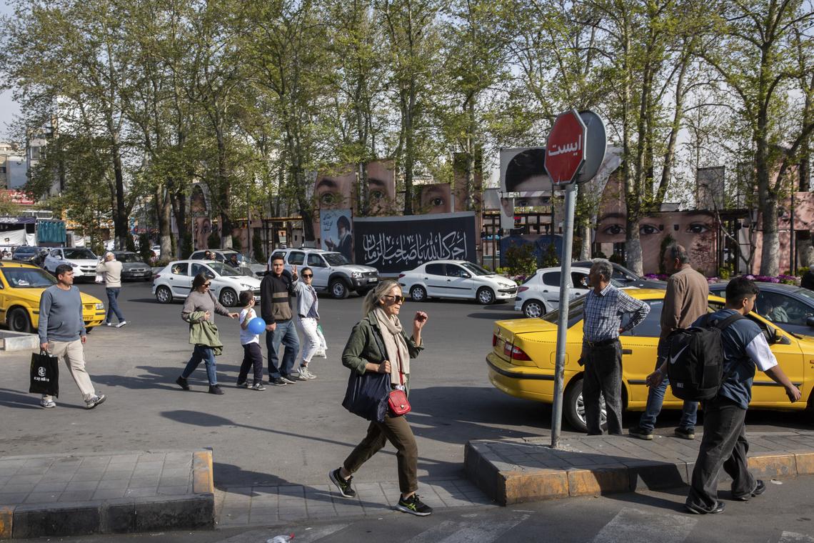 People walk near images of the victims of the Shajarah Tayyebeh elementary school strike in Minab on display at Tajrish Square in Tehran, on Thursday, April 16, 2026. President Donald Trump told reporters at the White House that the next in-person negotiations with Iran might occur this weekend. (Arash Khamooshi/The New York Times)