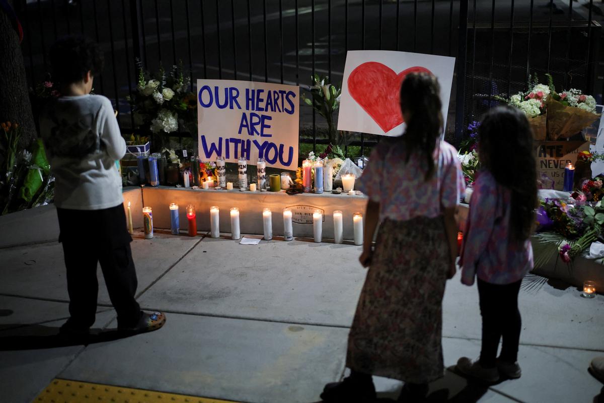 People pay their respects in front of the Islamic Center of San Diego after the vigil in a park, the day after a fatal shooting incident, in San Diego, California, U.S., May 19, 2026. REUTERS/Daniel Cole