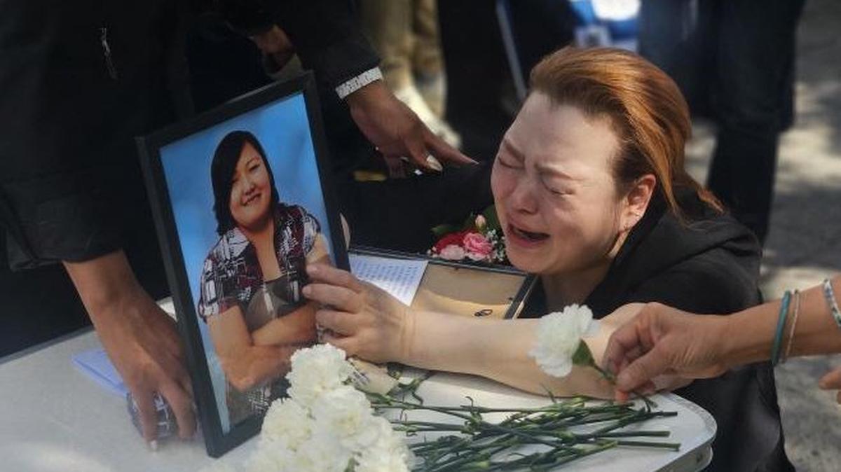 Lee Ae-rirana, a birth mother whose daughter was adopted to the United States, cries in front of a photo of her late daughter, Park Mi-ae, outside the Truth and Reconciliation Commission in Seoul on Friday. Photo by Asia Today