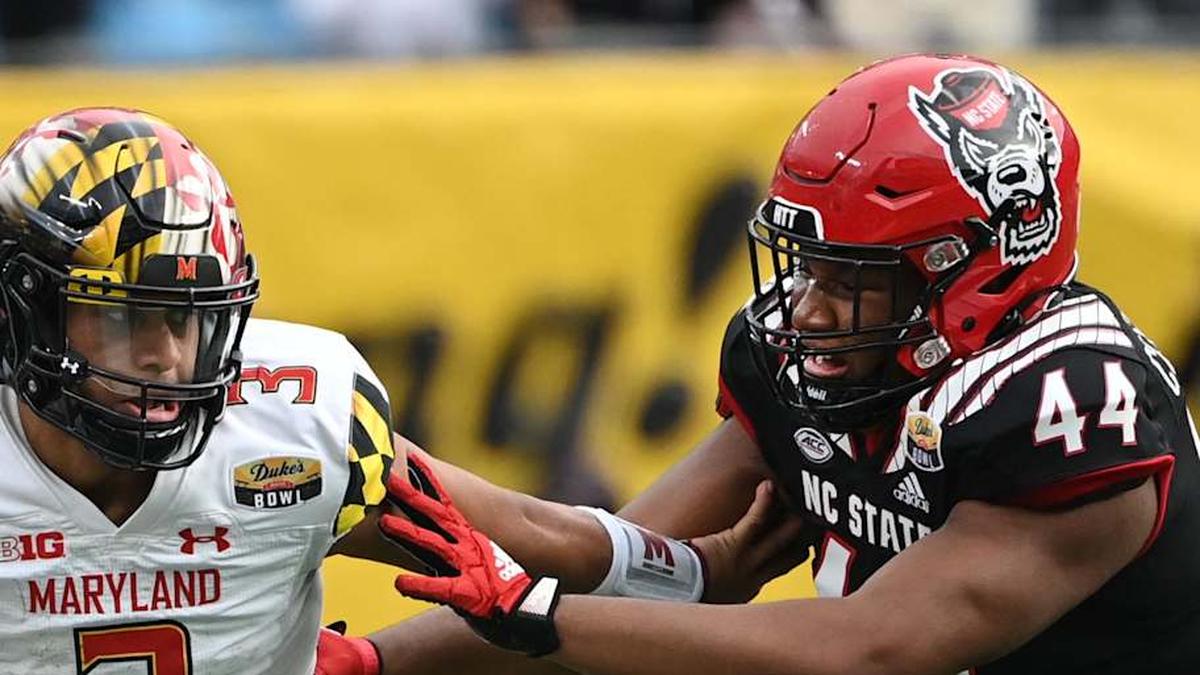  Dec 30, 2022; Charlotte, NC, USA; Maryland Terrapins quarterback Taulia Tagovailoa (3) scrambles as North Carolina State Wolfpack defensive lineman Brandon Cleveland (44) defends in the fourth quarter in the 2022 Duke's Mayo Bowl at Bank of America Stadium. Mandatory Credit: Bob Donnan-Imagn Images | Bob Donnan-Imagn Images 