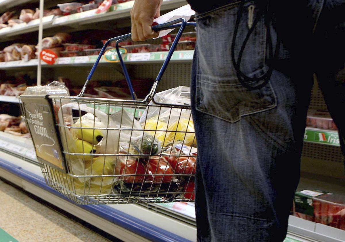 A person holds a shopping basket in a supermarket on August 29, 2023. 