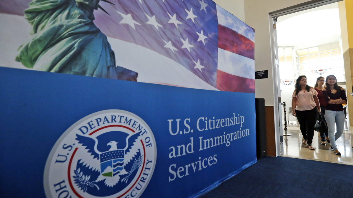 Citizenship Agency. People arrive before the start of a naturalization ceremony at the U.S. Citizenship and Immigration Services Miami Field Office in Miami. USCIS.