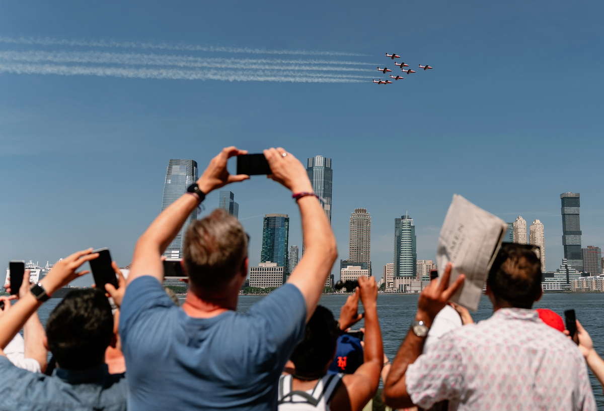 Spectators watch the International Aerial Review from Rockefeller Park in Lower Manhattan during the 250th anniversary of the United States' independence in New York, July 4, 2026. America celebrates the 250th anniversary of its independence today, with people from one end of the country to the other marking the milestone with fireworks, parades and concerts. (Lucia Vazquez/The New York Times)