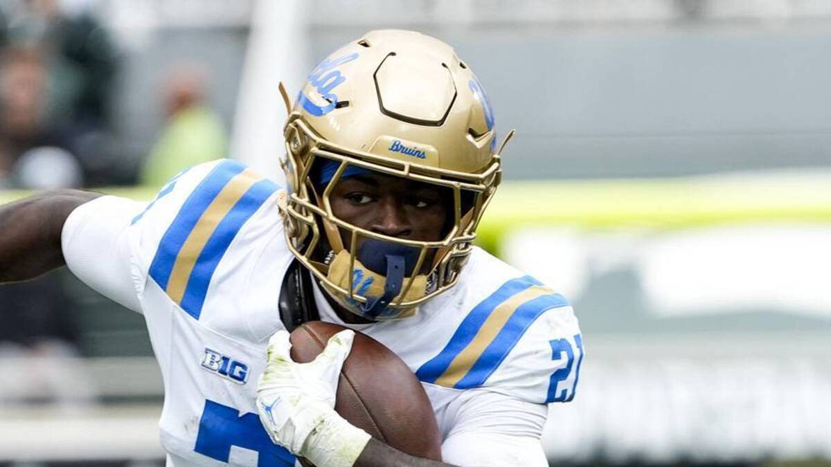  Oct 11, 2025; East Lansing, Michigan, USA; UCLA Bruins running back Jaivian Thomas (21) runs the ball in the second quarter at Spartan Stadium. Mandatory Credit: Brendan Mullin-Imagn Images | Brendan Mullin-Imagn Images 
