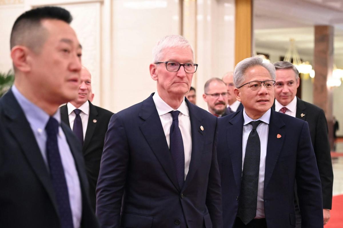  Tim Cook andJensen Huang, CEOs of Apple and Nvidia walk through the Great Hall of the People in Beijing. Johannes Neudecker/picture alliance via Getty Images 